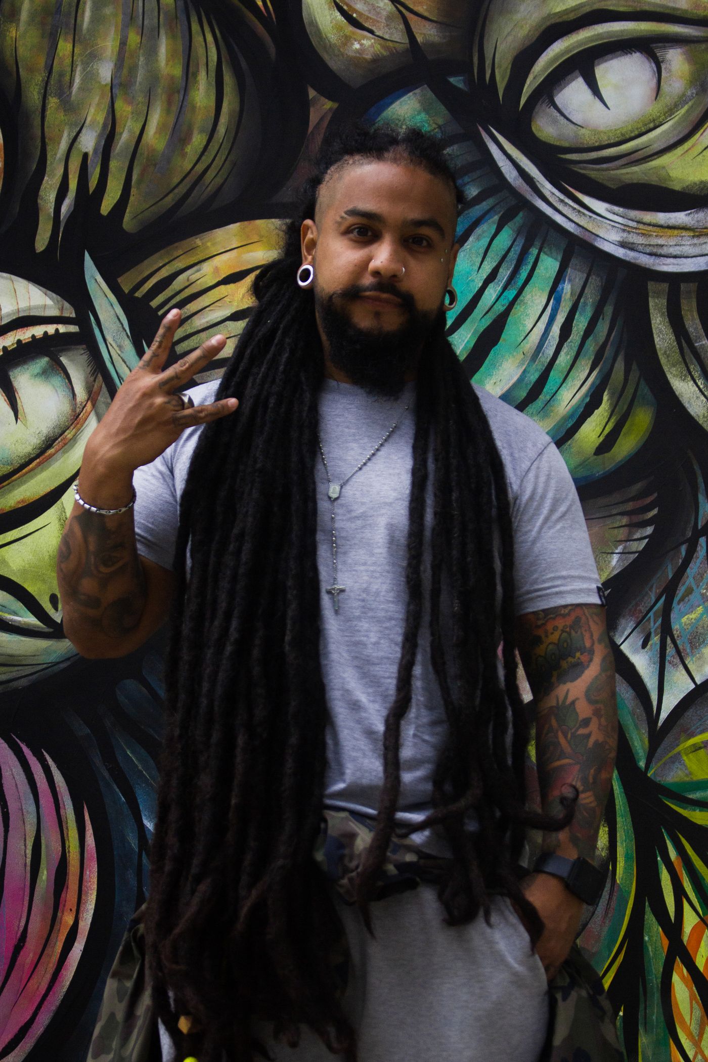 Freeform locs. Full-length locs, retwisted and finished with a barrel twist.