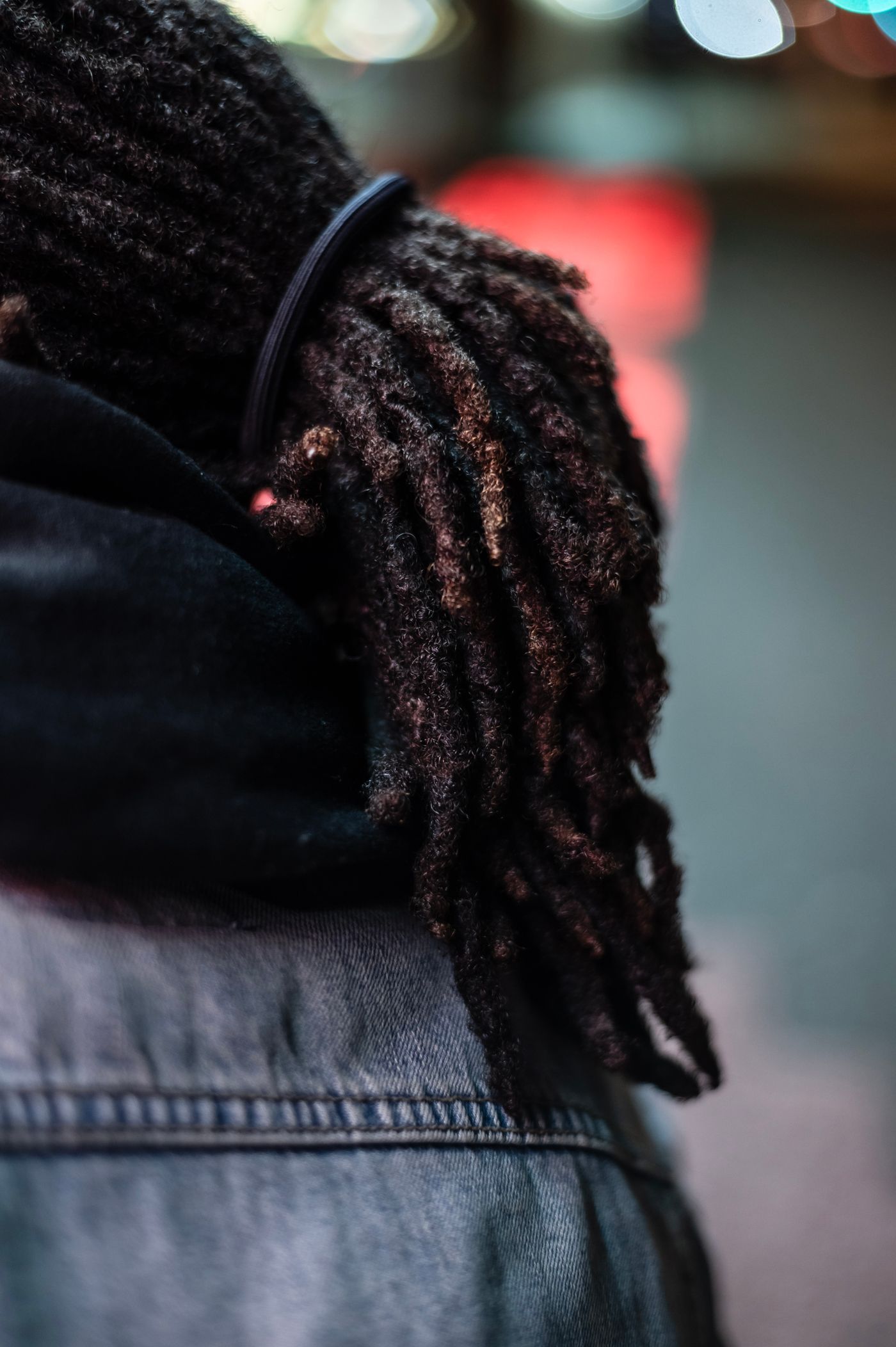 A close look at freshly retwisted locs resting over the shoulder
